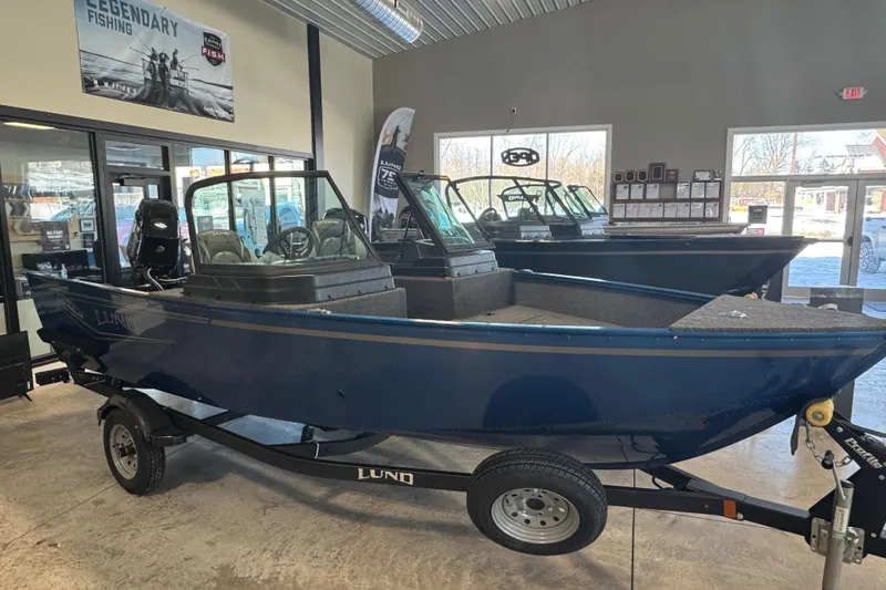 The Image of 2026 Lund 1650 Angler Sport boat displayed indoors, showcasing sleek design and modern features. - 1