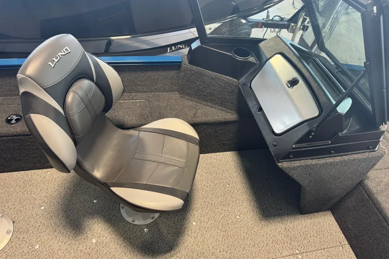Slide: The Image of 2026 Lund 1650 Angler Sport interior with swivel seat and console. - 8