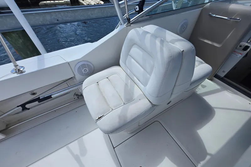 Slide: The Image of White captain's chair on 2005 Sea Ray 290 Amberjack boat deck. - 10