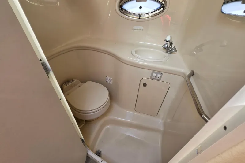 Slide: The Image of Compact bathroom in 2005 Sea Ray 290 Amberjack boat with toilet and sink. - 11