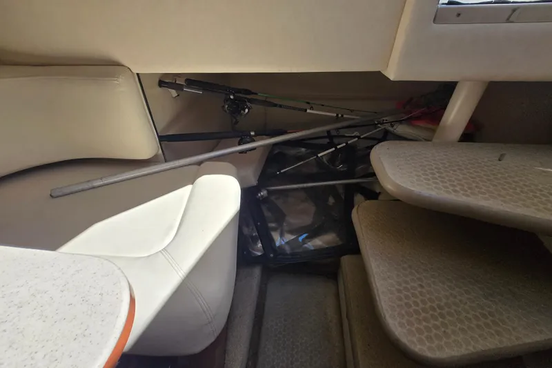 Slide: The Image of Interior of 2005 Sea Ray 290 Amberjack with fishing rods and seating area. - 19