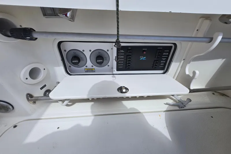 Slide: The Image of 2005 Sea Ray 290 Amberjack control panel with switches and gauges on a white background. - 26