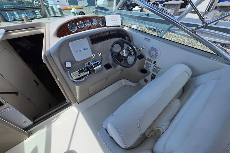 Slide: The Image of 2005 Sea Ray 290 Amberjack cockpit with steering wheel, controls, and navigation equipment. - 3