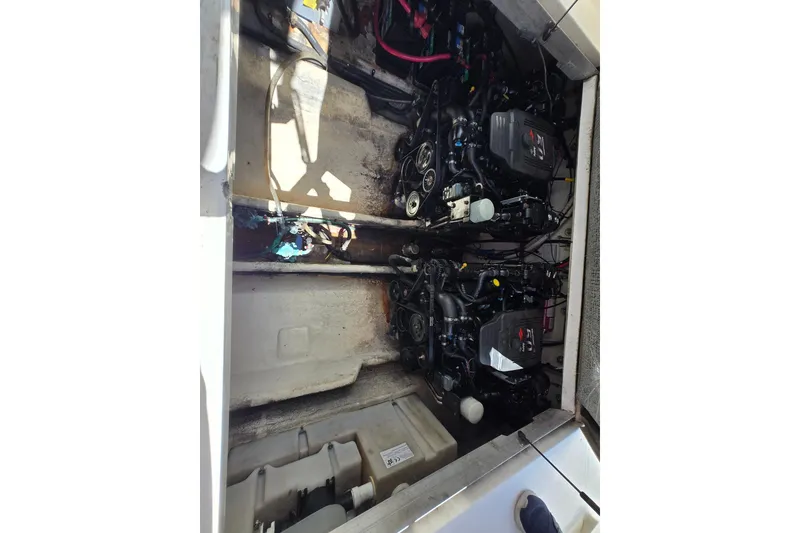 Slide: The Image of Engine compartment of 2005 Sea Ray 290 Amberjack, showcasing dual engines and mechanical components. - 6