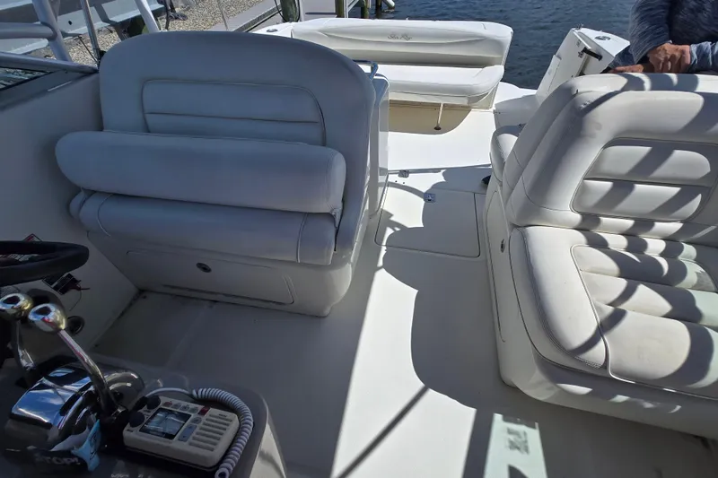 Slide: The Image of 2005 Sea Ray 290 Amberjack boat interior with white seating and control panel. - 8