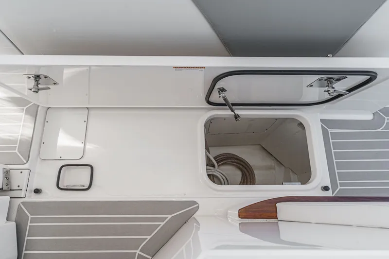 Slide: The Image of Interior of 2023 Tiara Yachts 48 LS with storage and seating area. - 30