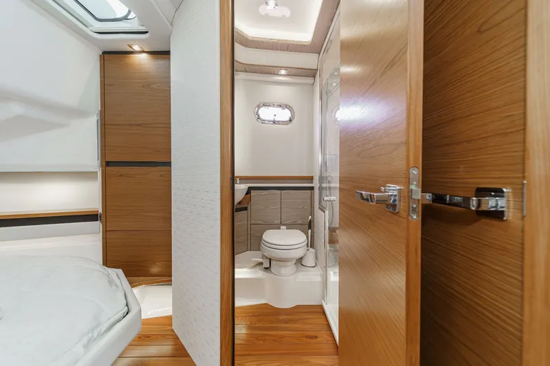 Slide: The Image of Interior of 2023 Tiara Yachts 48 LS featuring bathroom and wooden doors. - 36