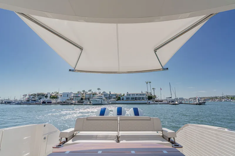 Slide: The Image of Tiara Yachts 48 LS 2023 with sunshade on calm waters. - 8
