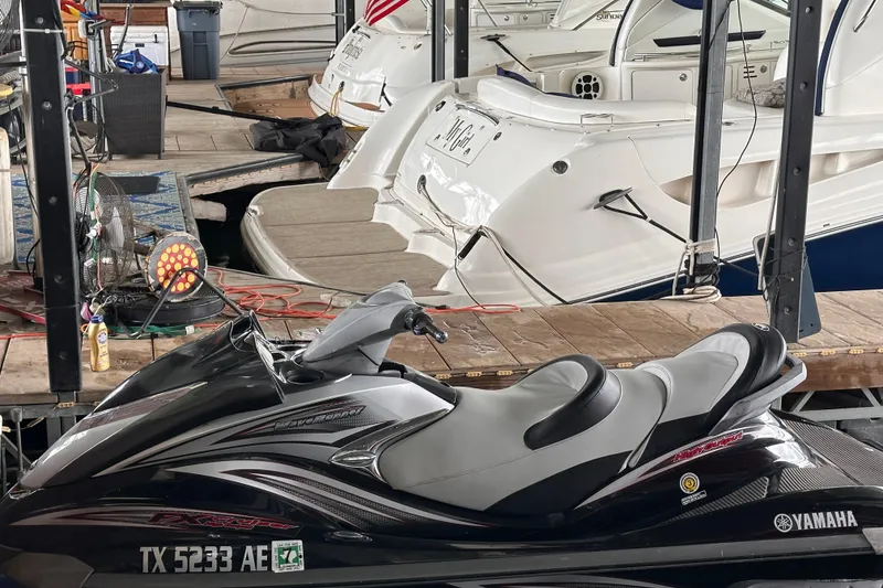 Slide: The Image of 2006 Yamaha WaveRunner FX Cruiser HO parked at a marina with boats in the background. - 5