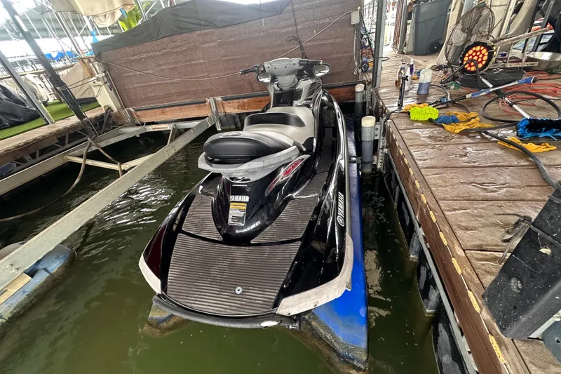 Slide: The Image of 2006 Yamaha WaveRunner FX Cruiser HO docked at marina, surrounded by maintenance tools. - 9