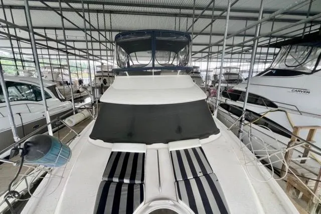 Slide: The Image of 2007 Meridian 368 Motoryacht in marina, covered and docked among other boats. - 14