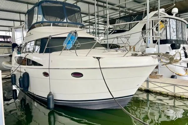 Slide: The Image of 2007 Meridian 368 Motoryacht docked in a marina, featuring sleek design and spacious cabin. - 2