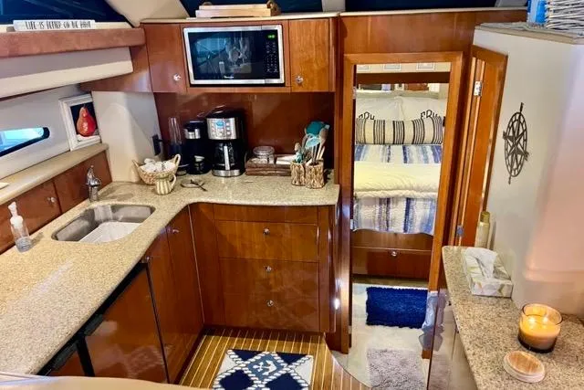 Slide: The Image of 2007 Meridian 368 Motoryacht interior with modern kitchen and cozy bedroom. - 20