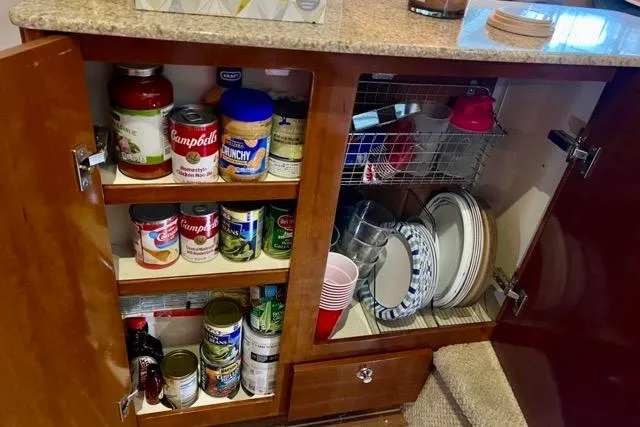 Slide: The Image of Cabinet storage in 2007 Meridian 368 Motoryacht with canned goods and dishware. - 21