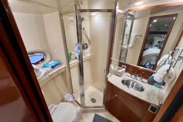 Slide: The Image of Luxurious bathroom in 2007 Meridian 368 Motoryacht with shower, sink, and porthole window. - 22