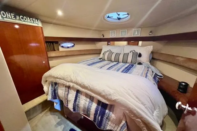 Slide: The Image of Cozy bedroom in 2007 Meridian 368 Motoryacht with nautical decor and porthole windows. - 23