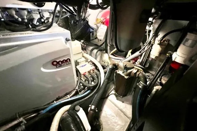 Slide: The Image of Engine room of 2007 Meridian 368 Motoryacht, showcasing mechanical components and wiring. - 33