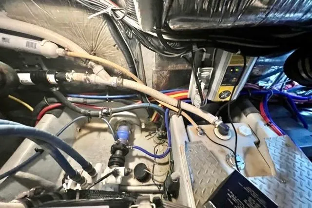 Slide: The Image of Engine room of a 2007 Meridian 368 Motoryacht with visible wiring and plumbing. - 36