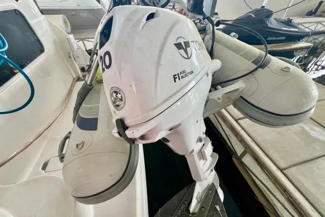Slide: The Image of Outboard motor on a 2007 Meridian 368 Motoryacht, docked with inflatable boat. - 39