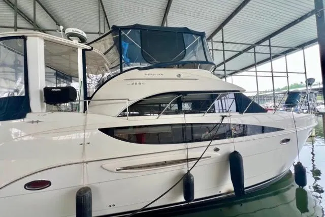 Slide: The Image of 2007 Meridian 368 Motoryacht docked in a covered marina, side view. - 4