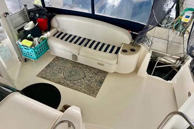 Slide: The Image of 2007 Meridian 368 Motoryacht interior with striped seating, rug, and storage basket. - 5