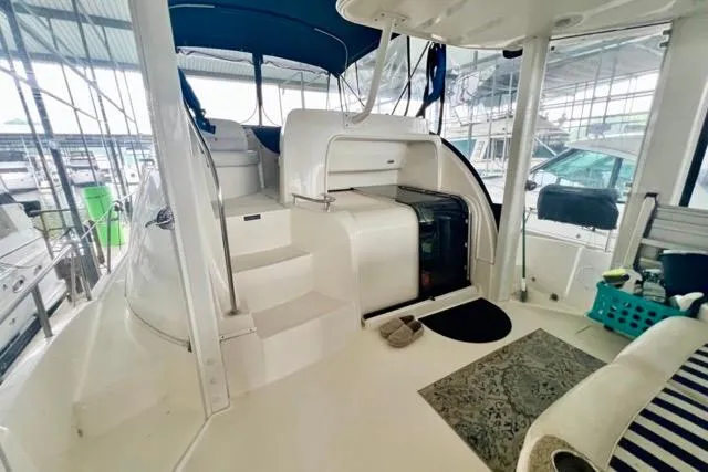 Slide: The Image of 2007 Meridian 368 Motoryacht interior with stairs, seating, and storage under a canopy. - 6