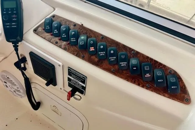 Slide: The Image of Control panel of a 2007 Meridian 368 Motoryacht with various switches and a radio. - 9