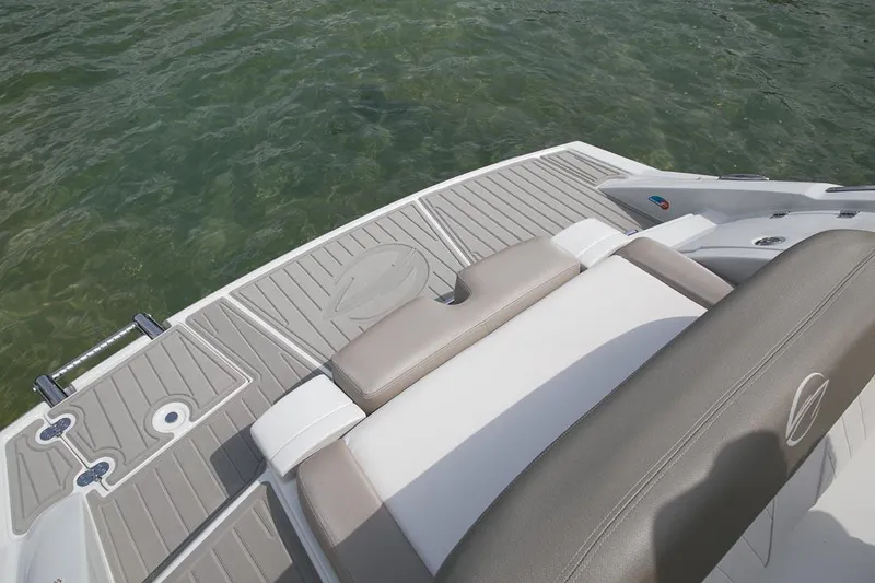 Slide: The Image of Manufacturer Provided Image: 2026 Crownline Eclipse E255 boat deck with seating, floating on clear water. - 10