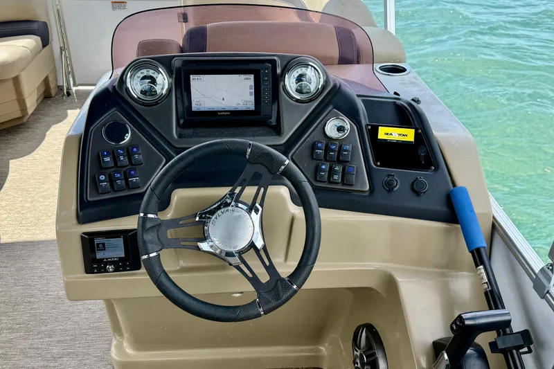 Slide: The Image of 2021 Sylvan L1 SPX boat dashboard with steering wheel and navigation controls. - 10