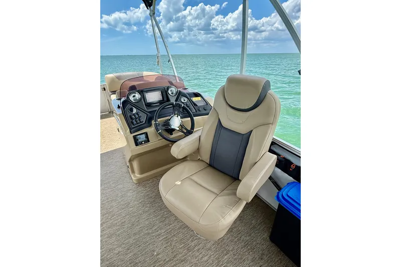 Slide: The Image of Captain's chair and helm of 2021 Sylvan L1 SPX boat with ocean view. - 12