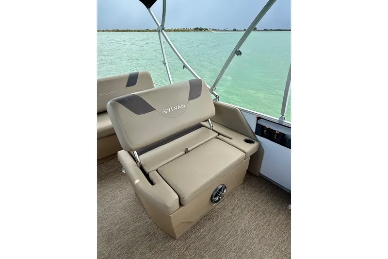 Slide: The Image of 2021 Sylvan L1 SPX boat interior with beige seating and lake view. - 15