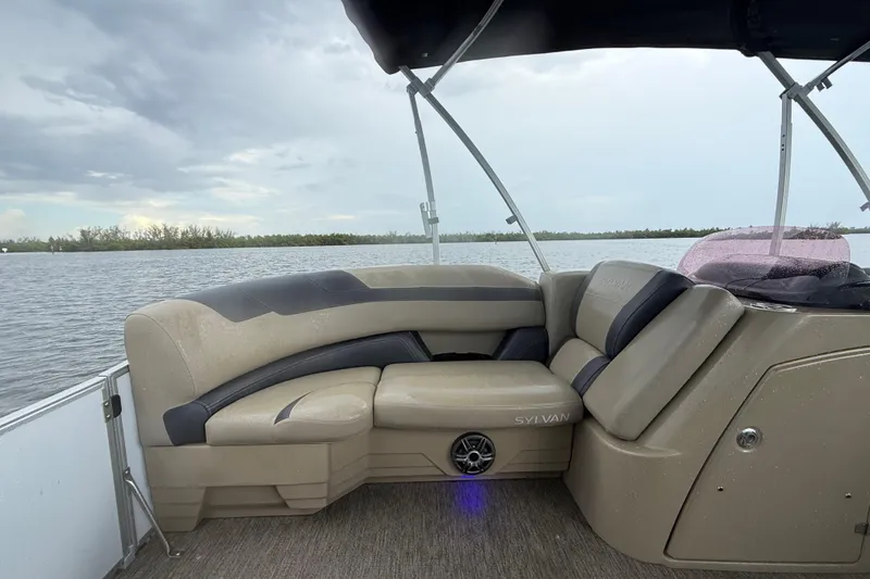Slide: The Image of 2021 Sylvan L1 SPX boat interior with comfortable seating on a calm lake. - 17