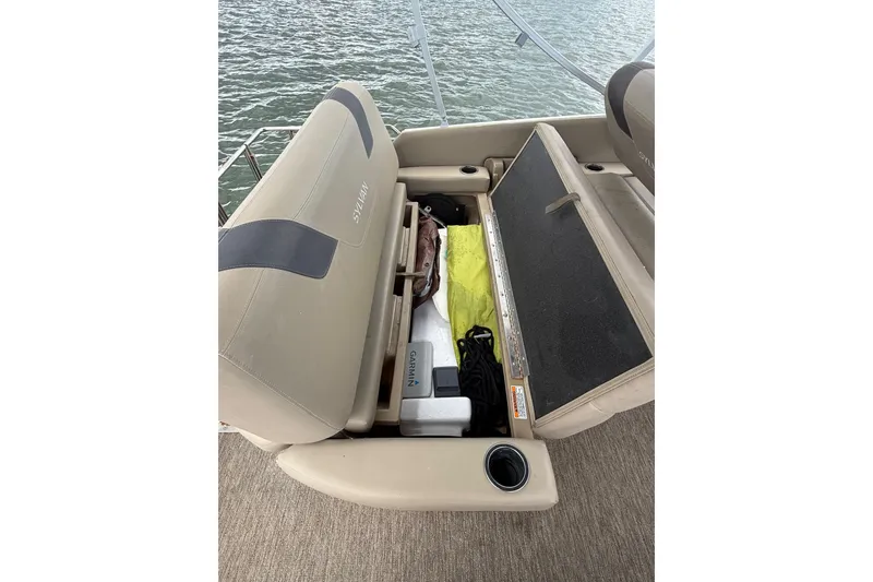 Slide: The Image of Open storage compartment on 2021 Sylvan L1 SPX boat with various items inside. - 20