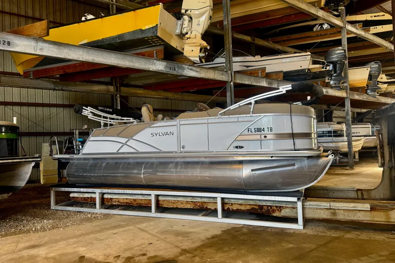 Slide: The Image of 2021 Sylvan L1 SPX pontoon boat stored in a covered marina rack. - 23