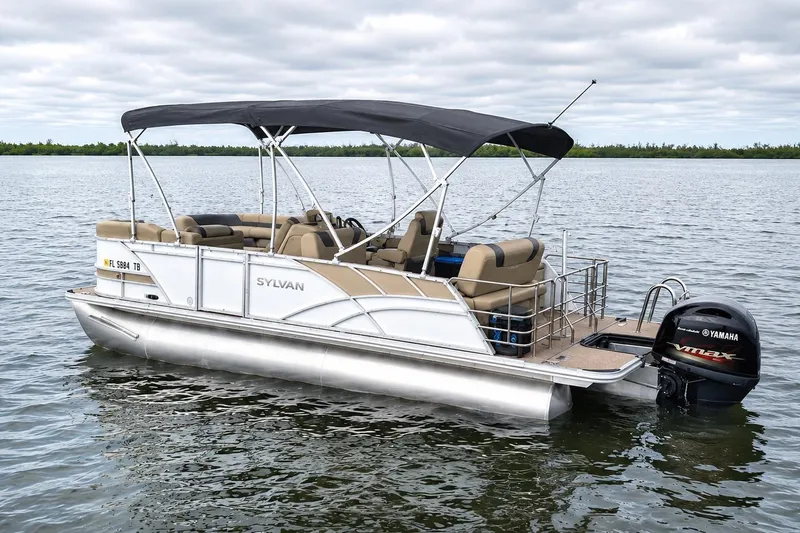 Slide: The Image of 2021 Sylvan L1 SPX pontoon boat on calm water with Yamaha outboard motor. - 3
