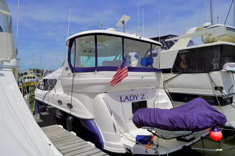 Slide: The Image of 2006 Sea Ray 40 Motor Yacht docked, featuring "Lady Z" name and American flag. - 1