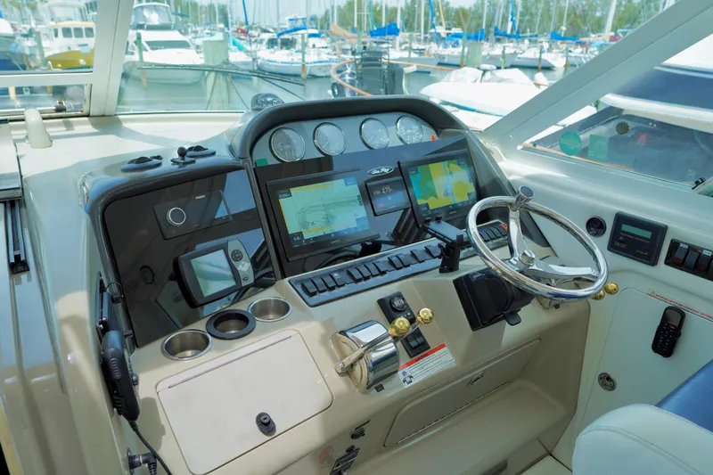 Slide: The Image of Control panel of a 2006 Sea Ray 40 Motor Yacht, featuring navigation instruments and steering wheel. - 10