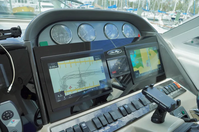 Slide: The Image of Dashboard of a 2006 Sea Ray 40 Motor Yacht with navigation screens and controls. - 11