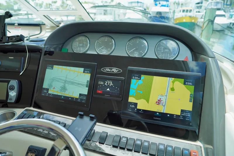 Slide: The Image of Dashboard of a 2006 Sea Ray 40 Motor Yacht with navigation screens and gauges. - 12