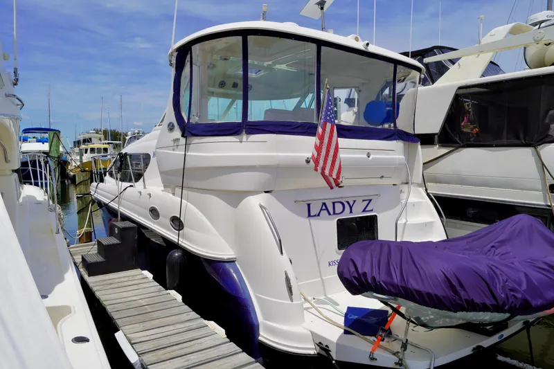 Slide: The Image of 2006 Sea Ray 40 Motor Yacht docked, featuring "Lady Z" name and American flag. - 2