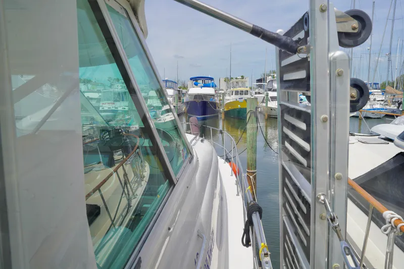 Slide: The Image of 2006 Sea Ray 40 Motor Yacht docked in a marina, surrounded by other boats. - 20