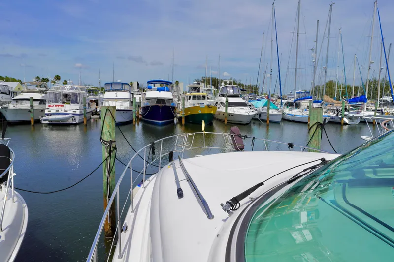 Slide: The Image of 2006 Sea Ray 40 Motor Yacht docked in a marina with various boats. - 21