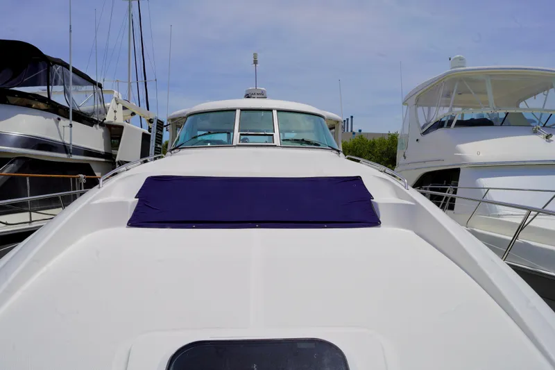 Slide: The Image of 2006 Sea Ray 40 Motor Yacht docked, featuring sleek design and spacious deck. - 25