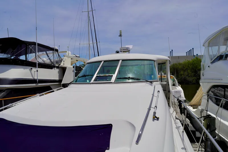 Slide: The Image of 2006 Sea Ray 40 Motor Yacht docked at marina, surrounded by other boats. - 26
