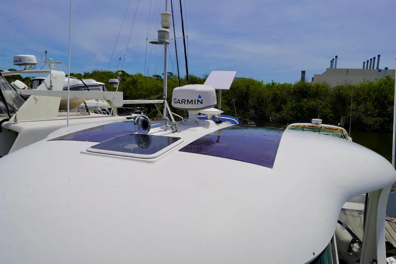 Slide: The Image of 2006 Sea Ray 40 Motor Yacht with Garmin equipment on deck, docked near greenery. - 27