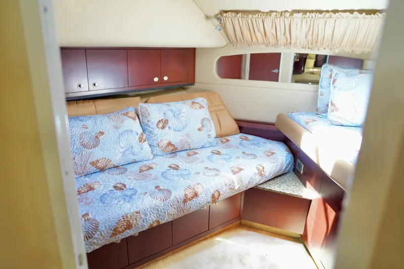 Slide: The Image of Interior cabin of 2006 Sea Ray 40 Motor Yacht with cozy bedding and wooden cabinets. - 29