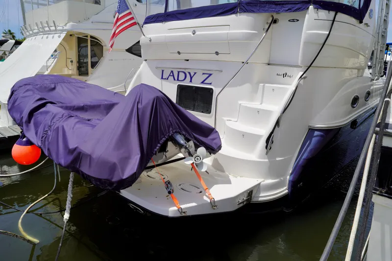 Slide: The Image of 2006 Sea Ray 40 Motor Yacht docked with covered dinghy and American flag. - 3