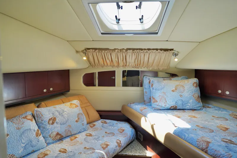 Slide: The Image of Luxurious 2006 Sea Ray 40 Motor Yacht cabin with cozy bedding and natural light. - 30