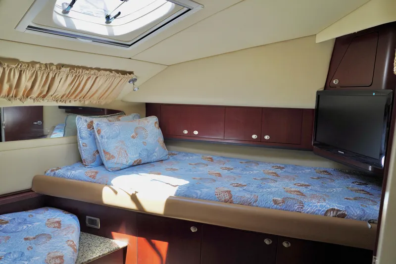 Slide: The Image of Luxurious 2006 Sea Ray 40 Motor Yacht cabin with cozy bed and TV. - 31