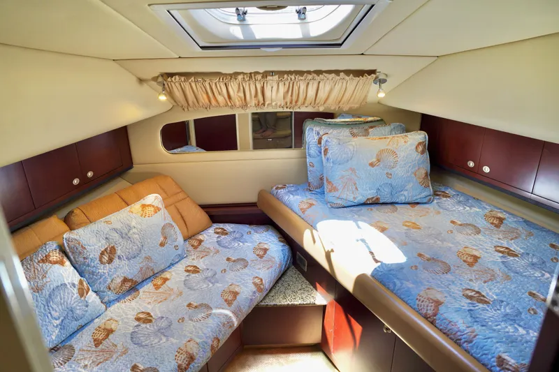 Slide: The Image of Luxurious 2006 Sea Ray 40 Motor Yacht cabin with cozy bedding and elegant wood finishes. - 33